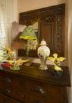 Dresser with decorative birds and mirror in the back